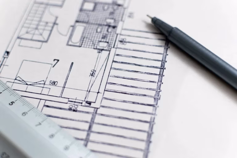 Architekturpläne mit Stift auf einem Schreibtisch